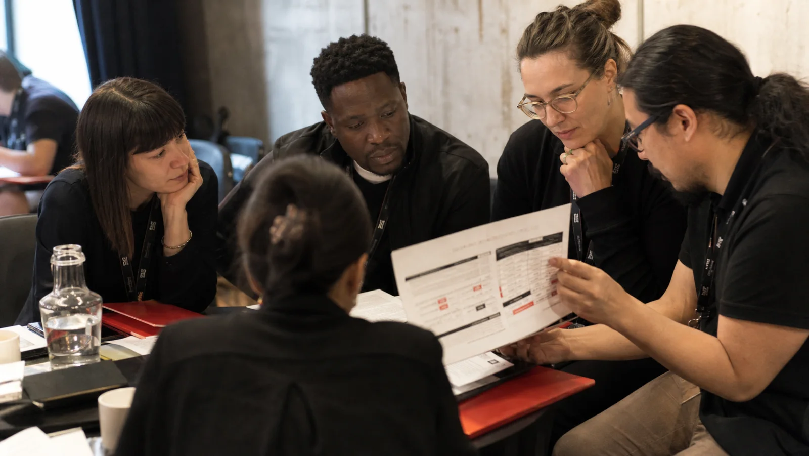 Festival organizers from different cities comparing programs at an industry meeting